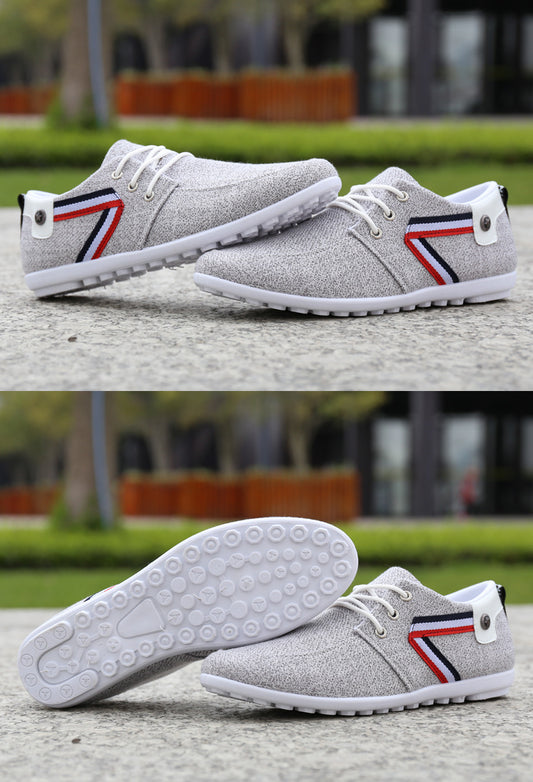 Gray textured casual sneakers with red, white, and blue stripe detail, white laces, and patterned sole