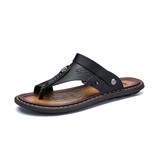 Black leather thong sandal with embossed logo, stitched sole, and metallic accents — luxury men's footwear