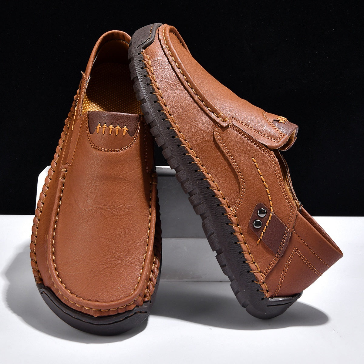 Brown leather loafers with contrast stitching and textured soles