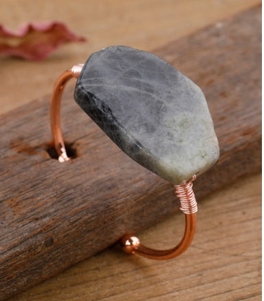 Handcrafted copper cuff bracelet with raw gray stone, minimalist luxury jewelry design
