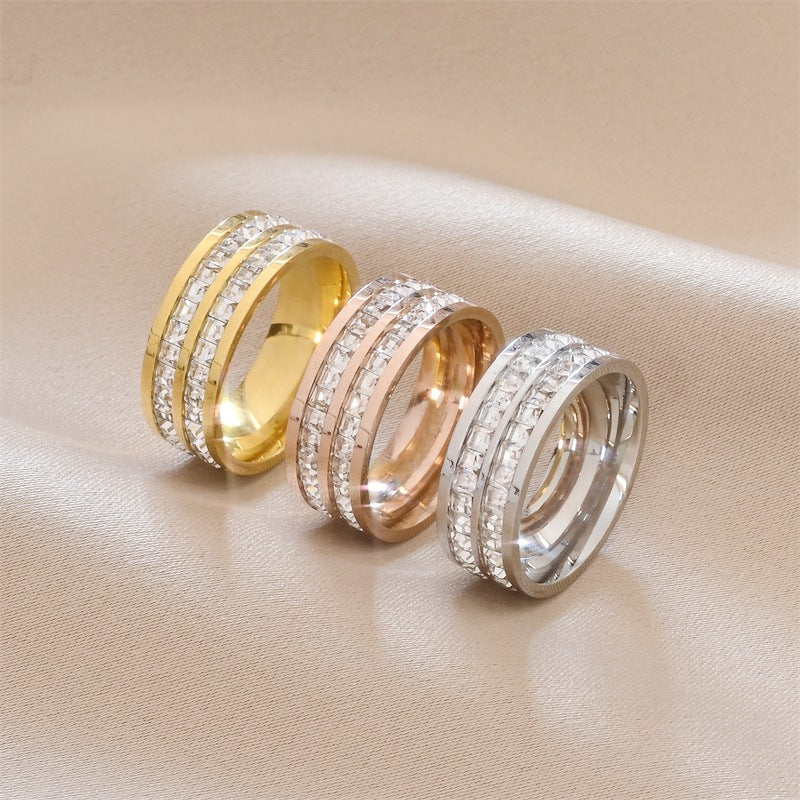 Luxury diamond-encrusted rings in gold, rose gold, and silver tones on satin background