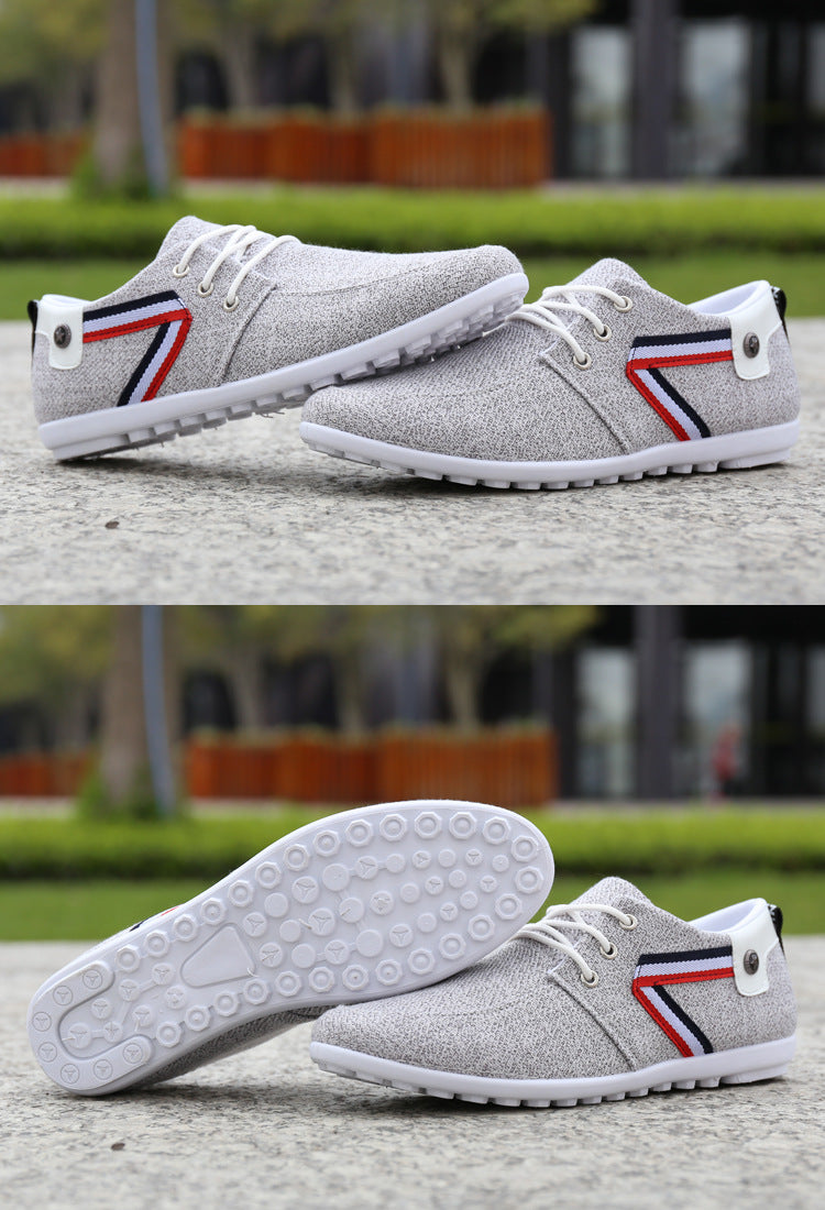 Gray textured casual sneakers with red, white, and blue stripe detail, white laces, and patterned sole