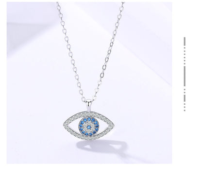 Elegant evil eye pendant necklace with blue and clear crystals, minimalist luxury jewelry design