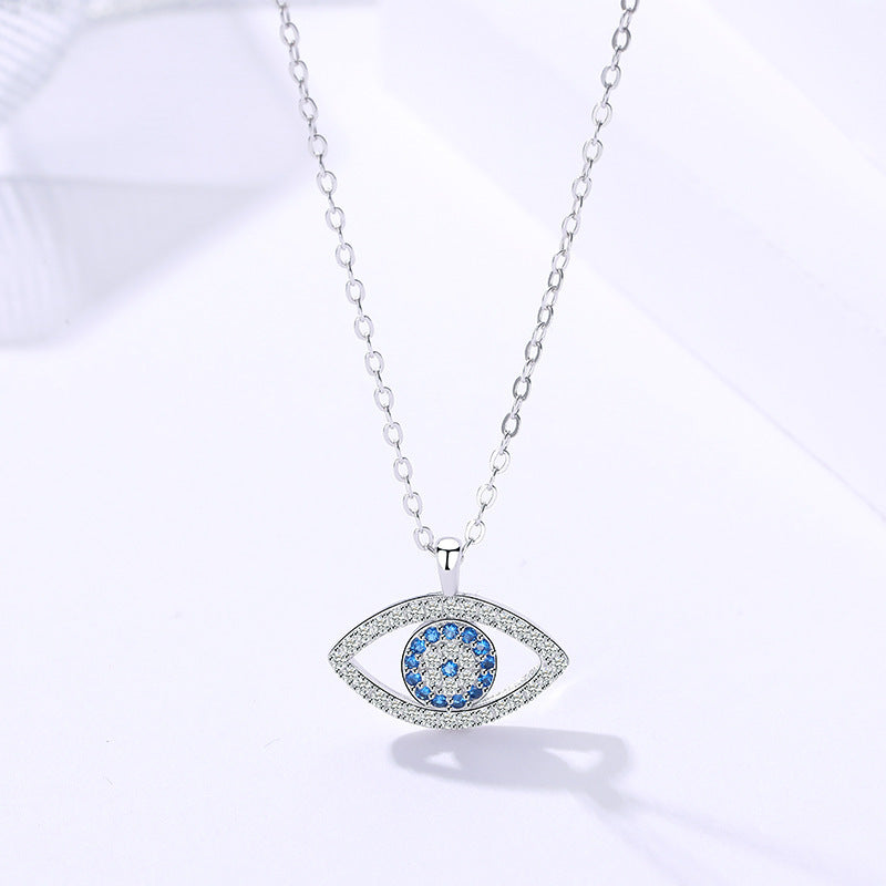 Elegant evil eye pendant necklace with blue and clear crystals, minimalist luxury jewelry design