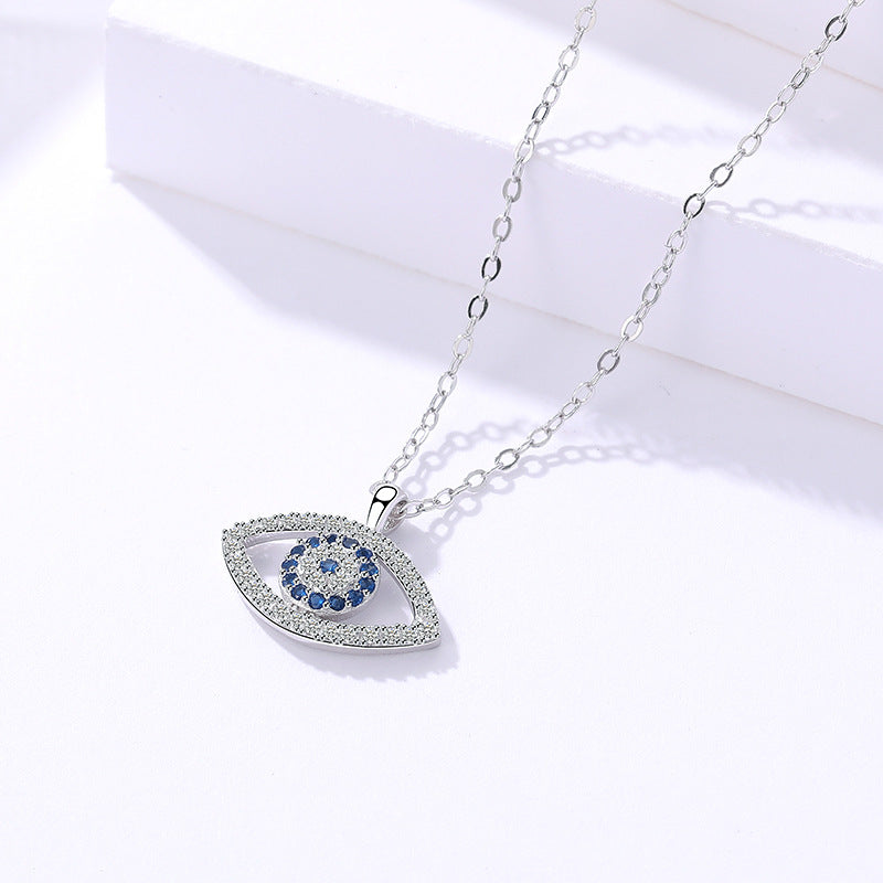 Elegant evil eye pendant necklace with blue and clear crystals, minimalist luxury jewelry design