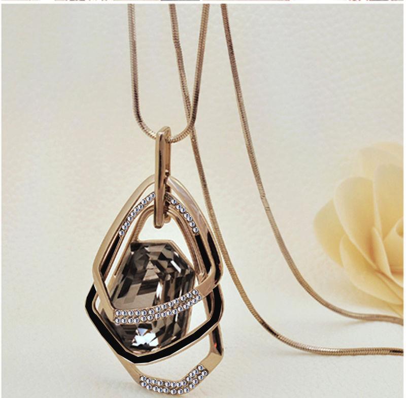 Luxury geometric pendant necklace with faceted gemstone and crystal accents, minimalist design