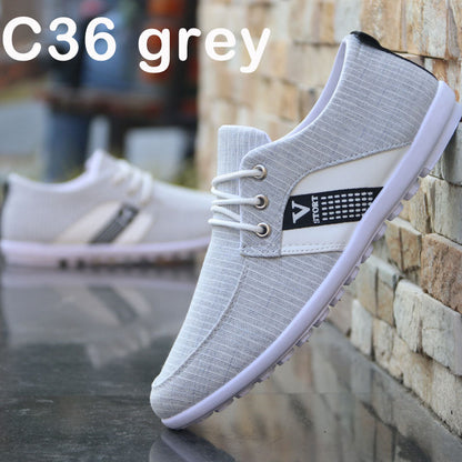 Grey C36 casual sneaker with white laces and sporty side panel, styled against brick wall