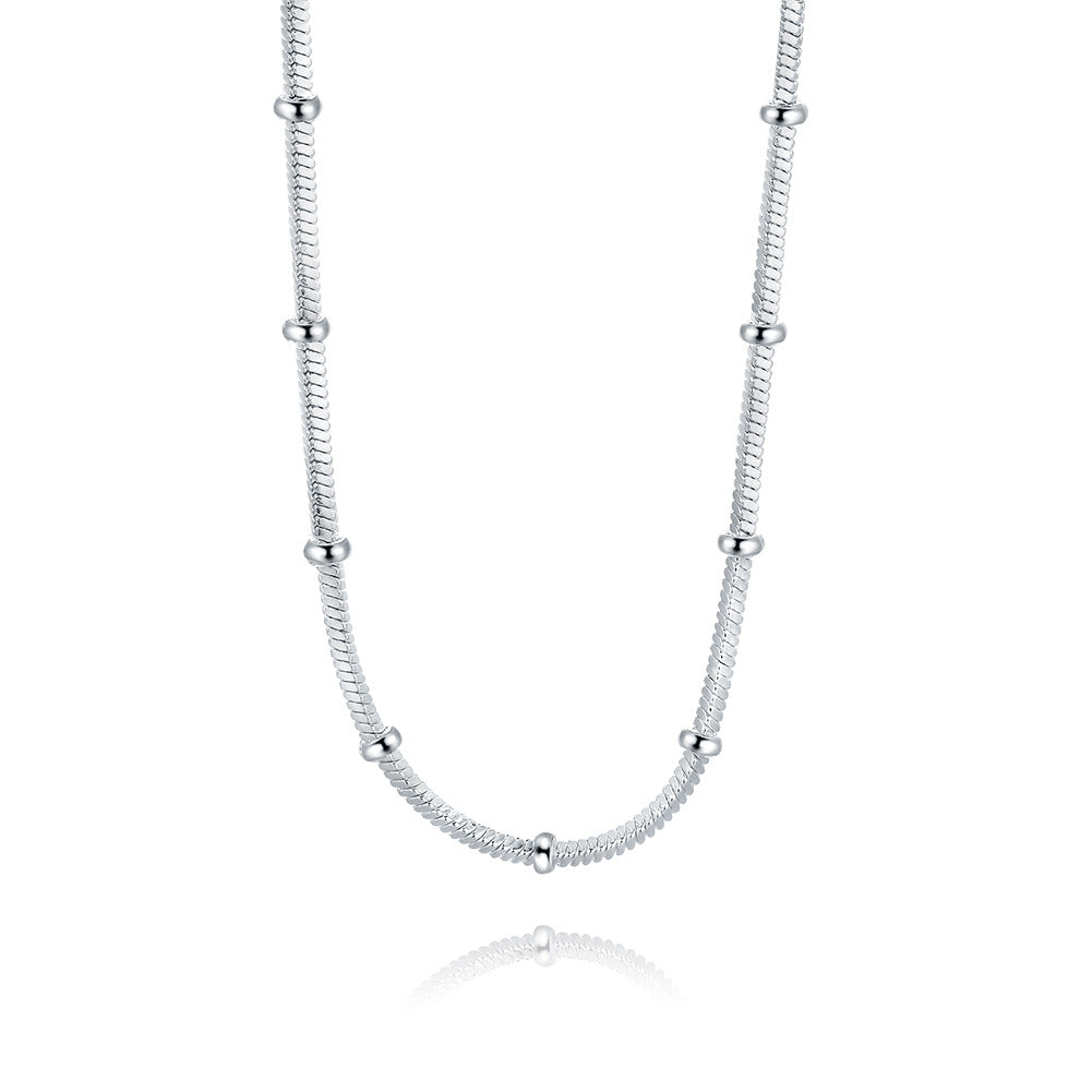 Minimalist silver snake chain necklace with spaced spherical beads, luxury jewelry design
