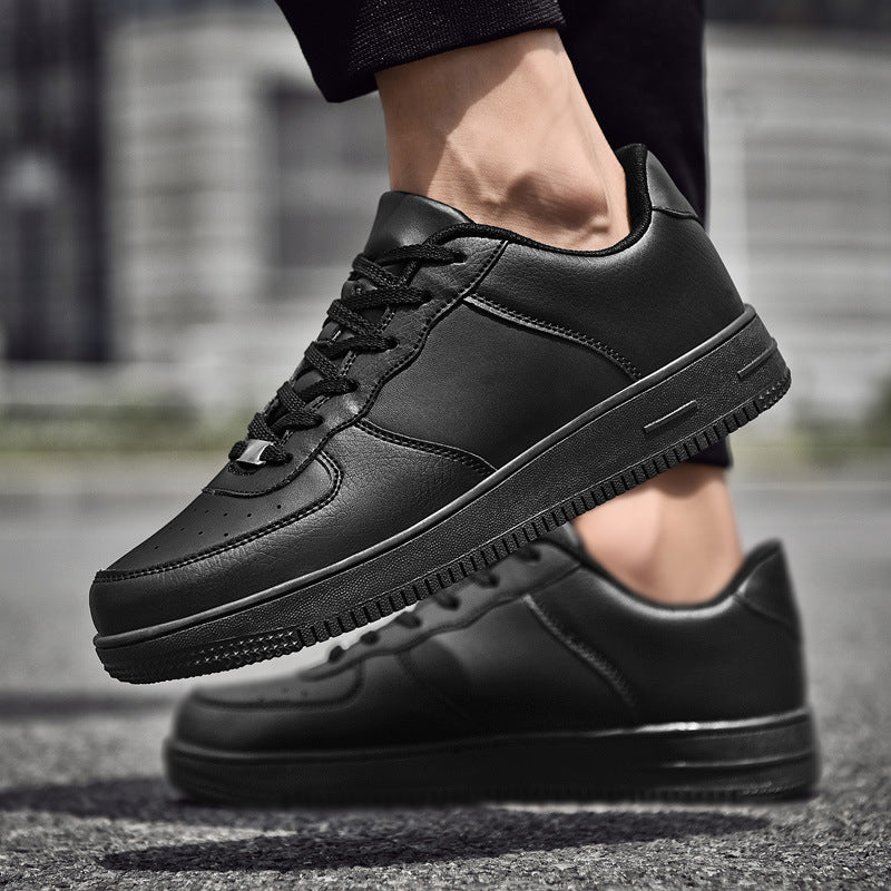 Black minimalist leather sneakers with clean design and textured sole, perfect for urban style.