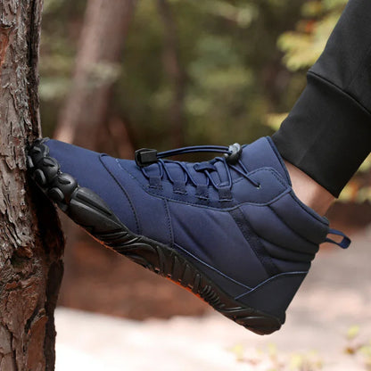 Navy blue minimalist hiking boot with rugged sole, worn outdoors near tree trunk