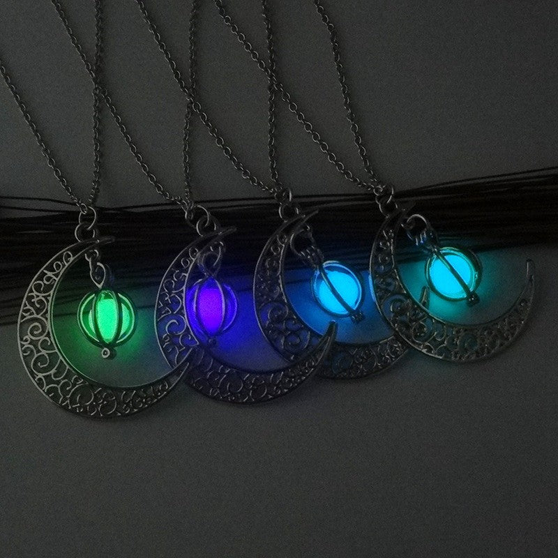 Glowing moon pendant necklaces in green, purple, blue, and teal — luminous, minimalist jewelry design