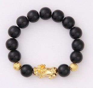 Black beaded bracelet with gold Pi Xiu charm, luxury minimalist design