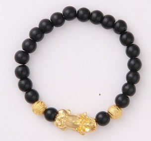 Black beaded bracelet with gold charm, minimalist luxury jewelry design