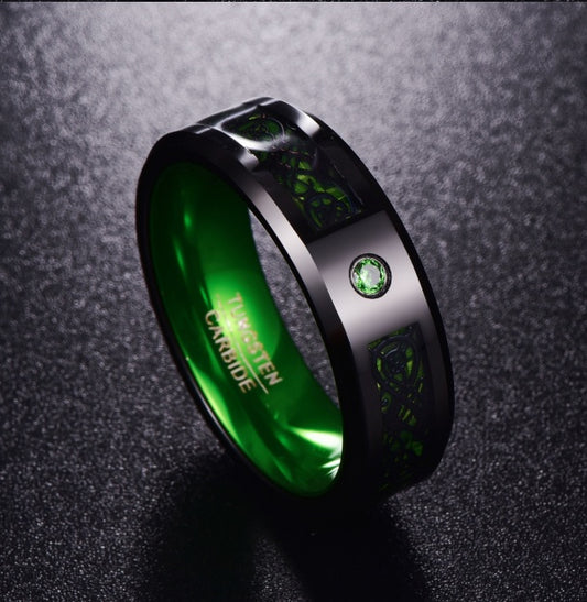 Black tungsten carbide ring with green inlay, Celtic design, and emerald accent stone — luxury men's jewelry