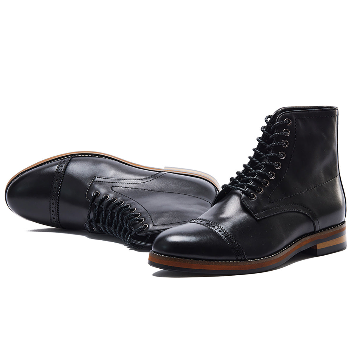 Black leather cap-toe lace-up boots with brown sole, minimalist luxury footwear design