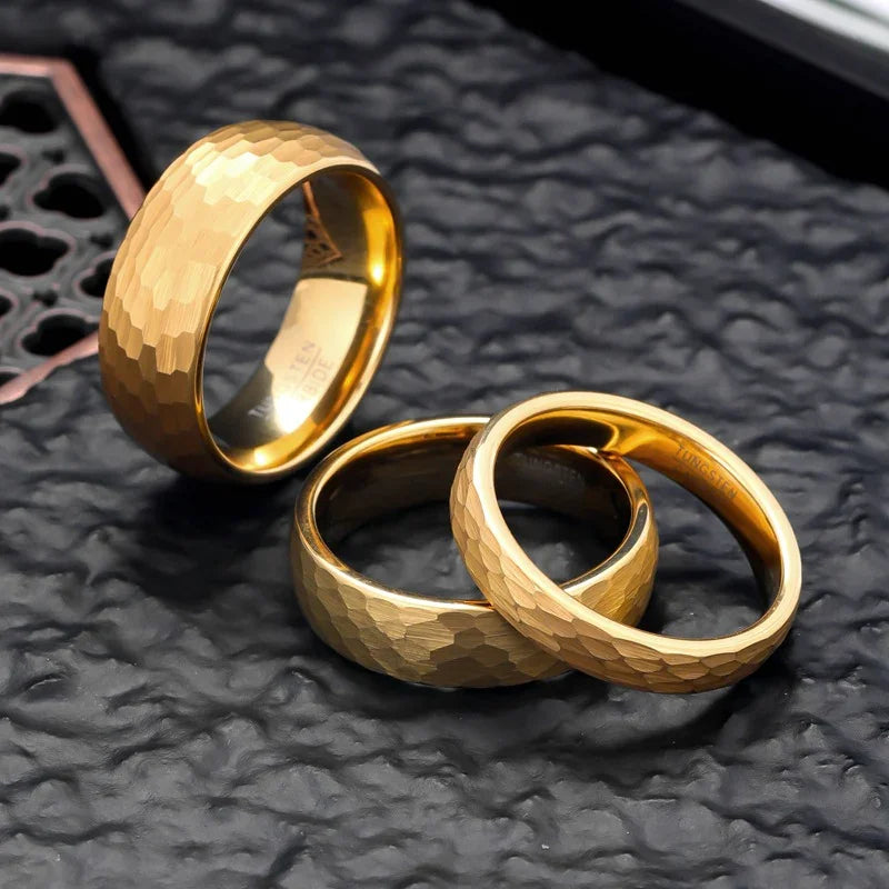 Luxury gold rings with hammered texture, minimalist design, premium craftsmanship on dark textured surface