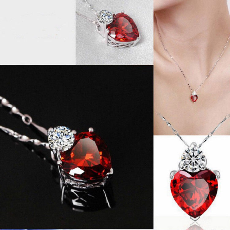 Heart-shaped red gemstone pendant necklace with diamond accent, luxury jewelry design