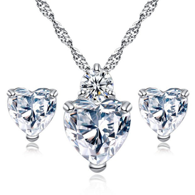 Heart-shaped diamond pendant necklace and matching stud earrings, luxury jewelry set with sparkling stones
