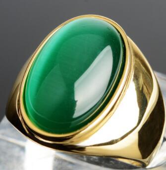 Luxury gold ring with vibrant green cabochon stone, minimalist design, premium craftsmanship