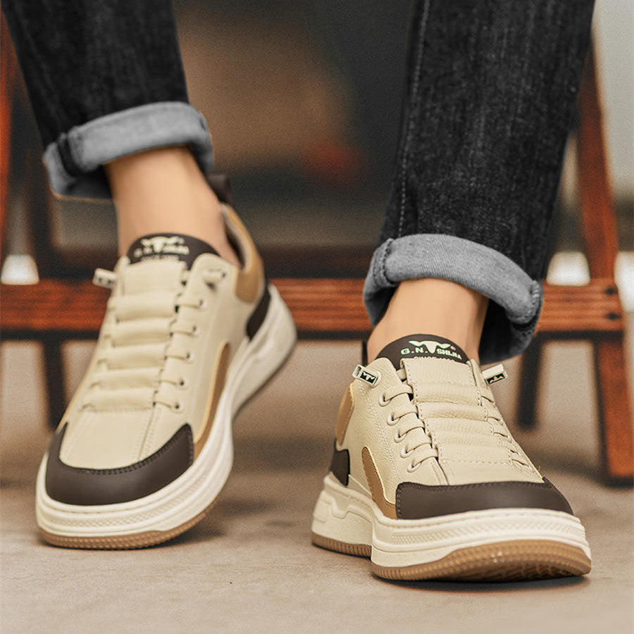 Beige and brown minimalist sneakers with chunky soles, styled with cuffed jeans for casual luxury footwear.