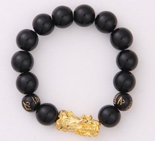 Black beaded bracelet with gold dragon charm, minimalist luxury jewelry design