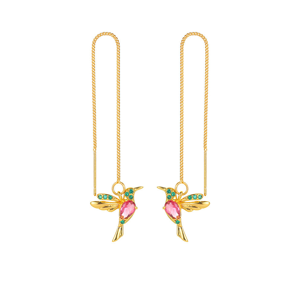 Gold hummingbird earrings with pink gemstone body and green crystal wings, minimalist luxury jewelry design