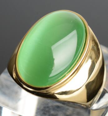 Luxury gold ring with vibrant green cabochon stone, minimalist design, premium quality jewelry