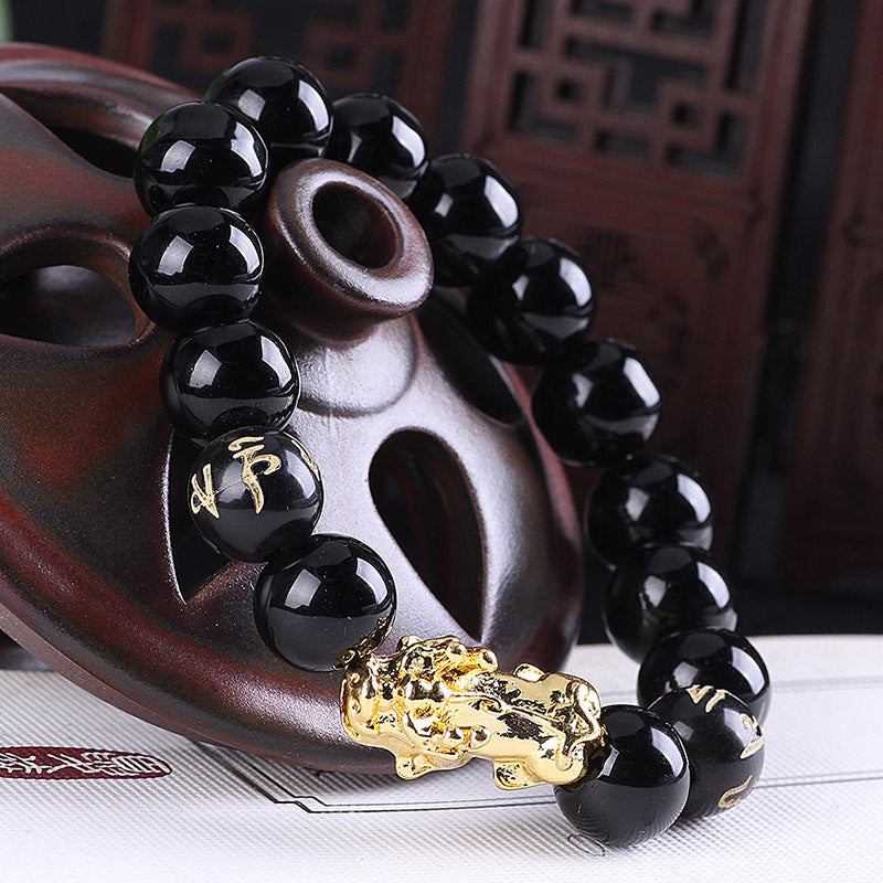 Luxury black onyx beaded bracelet with gold Pi Xiu charm, minimalist design, premium handcrafted jewelry