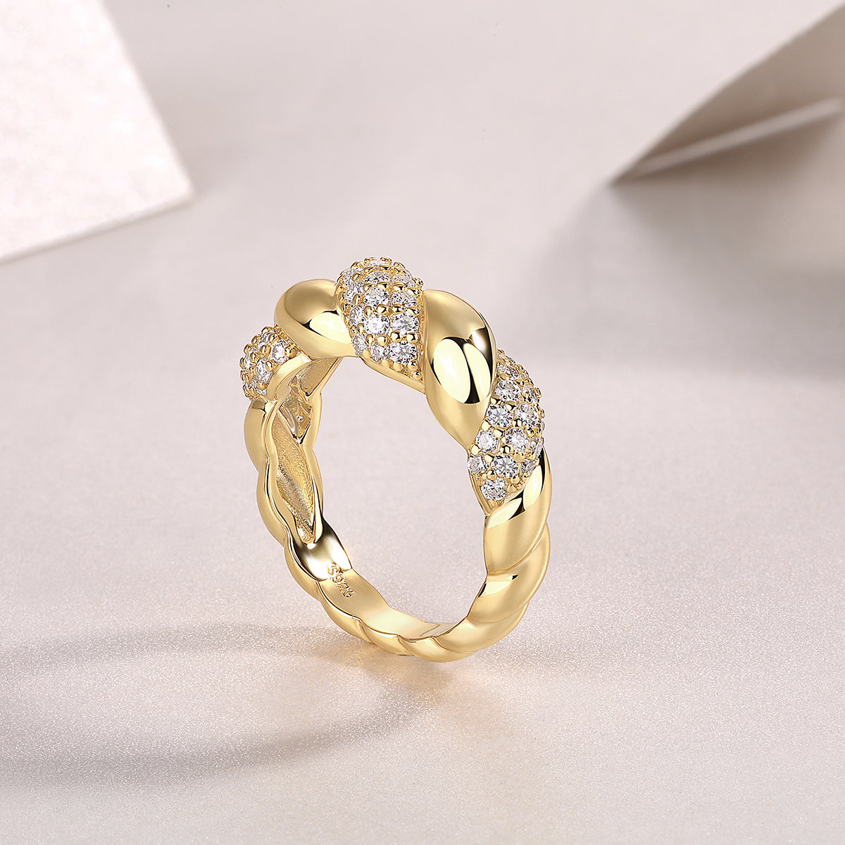Luxury gold ring with twisted design and diamond clusters, minimalist premium jewelry