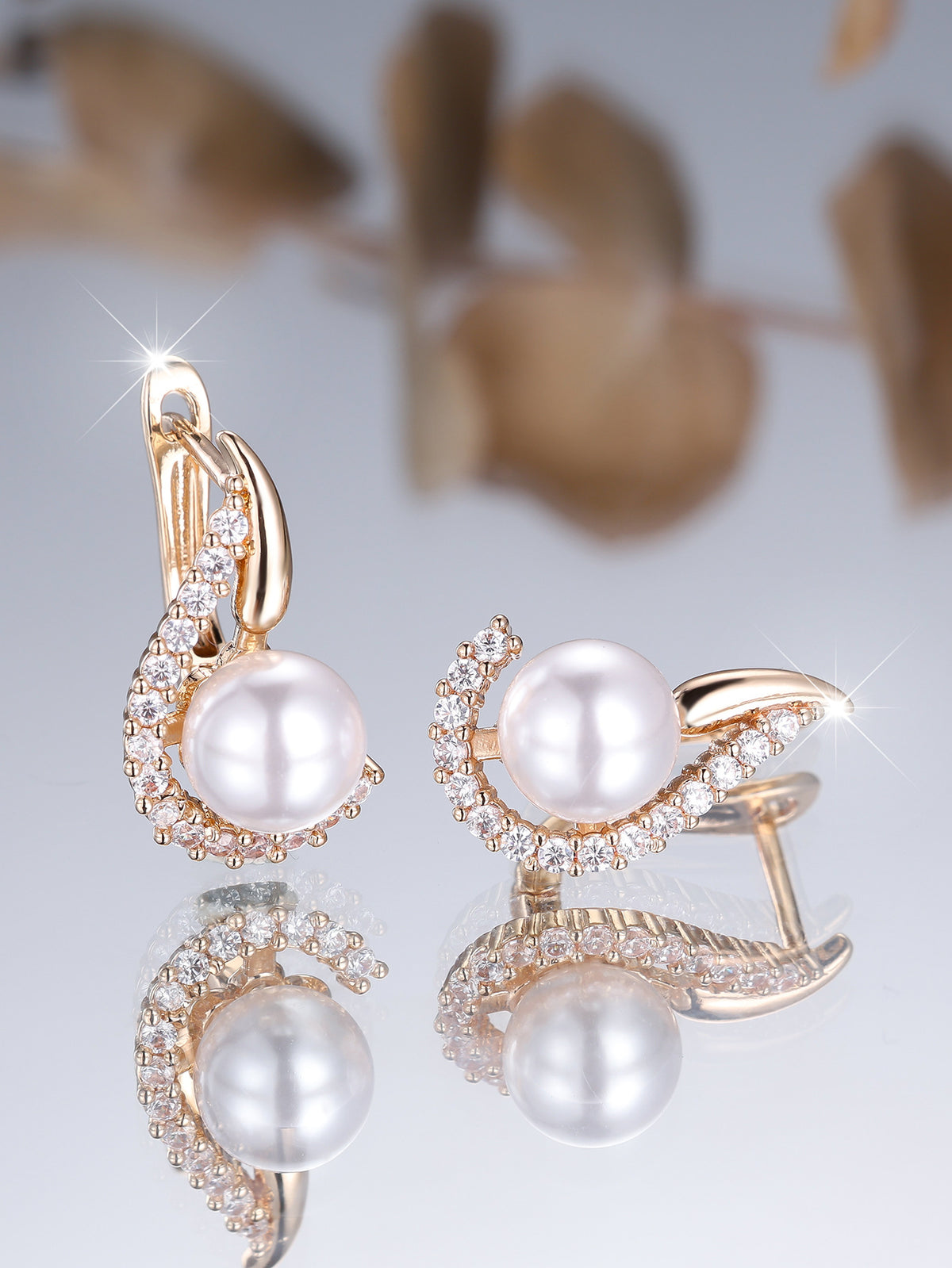 Elegant pearl earrings with rose gold and crystal accents, minimalist luxury design