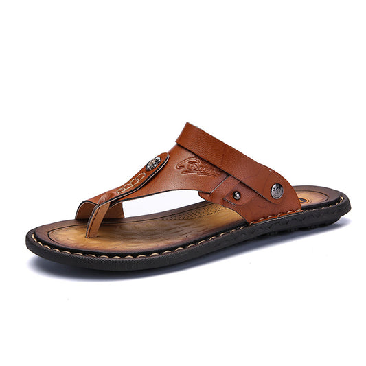 Brown leather thong sandal with decorative stud and stitched sole, minimalist design