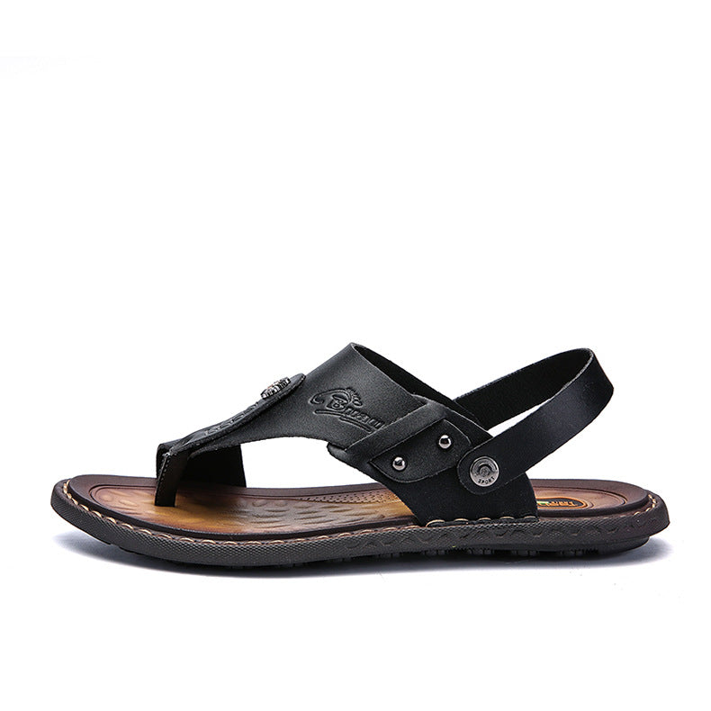 Black leather men's thong sandal with adjustable strap and cushioned sole, minimalist design