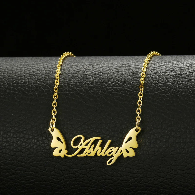 Gold name necklace with butterfly wings, personalized 'Ashley' pendant on black leather