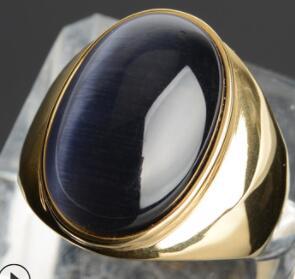 Luxury gold ring with oval blue cat's eye gemstone, minimalist design, premium craftsmanship