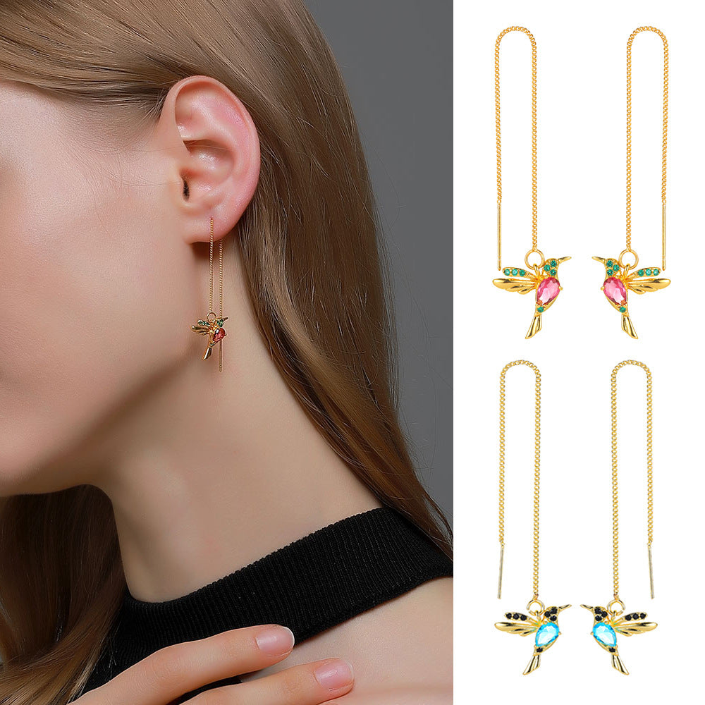 Gold hummingbird drop earrings with pink and blue gemstones, minimalist luxury jewelry design