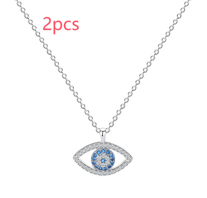 Silver evil eye pendant necklace with blue and clear crystals, minimalist luxury jewelry design
