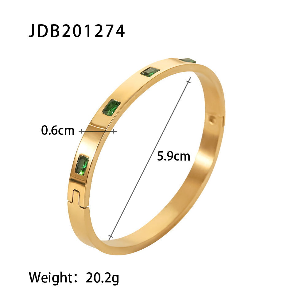 Gold bangle with emerald green stones, 5.9cm diameter, minimalist luxury jewelry design