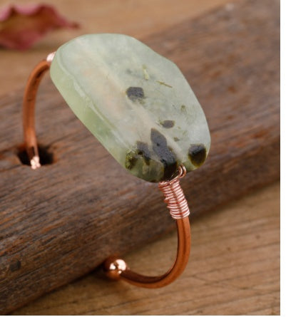 Handcrafted copper cuff bracelet with natural green stone, minimalist luxury jewelry design
