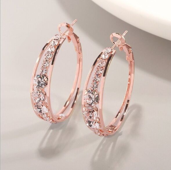 Rose gold hoop earrings with sparkling crystals, minimalist luxury jewelry design