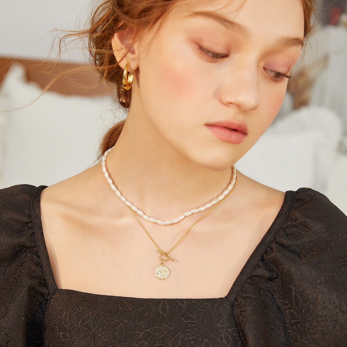 VTX Liora gold double-layer necklace styled on neckline