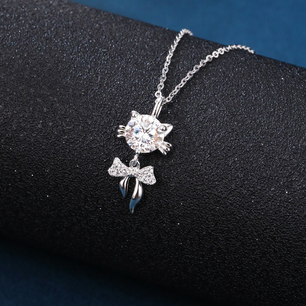 Sparkling cat pendant necklace with crystal bow charm, luxury minimalist jewelry on black display