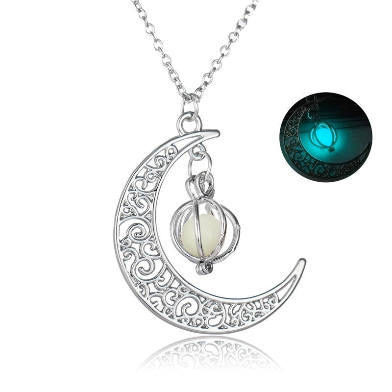Silver crescent moon necklace with glowing orb pendant, intricate filigree design, luminous glow-in-the-dark feature