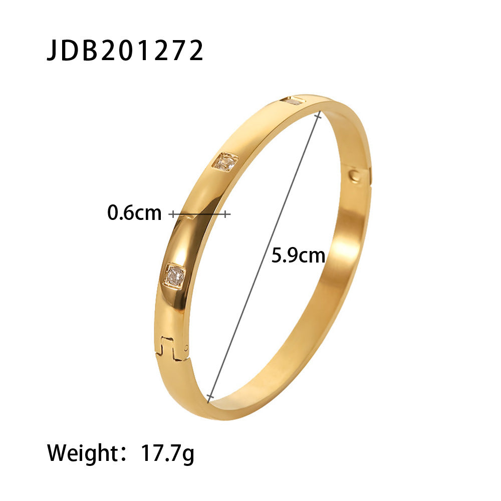 Gold bangle with embedded crystals, 5.9cm diameter, minimalist luxury jewelry design