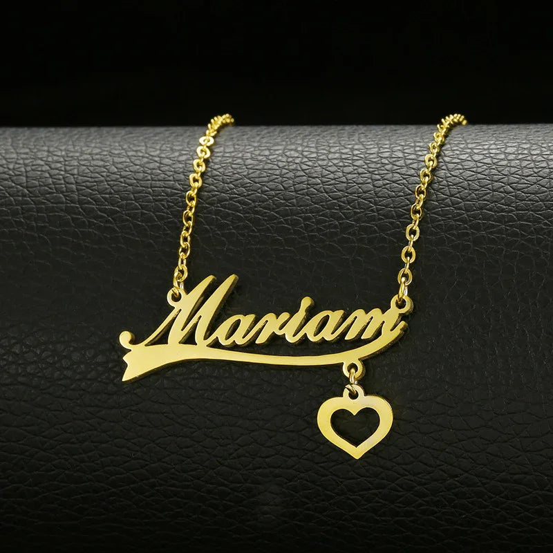 Gold name necklace with 'Mariam' script and heart pendant on black leather