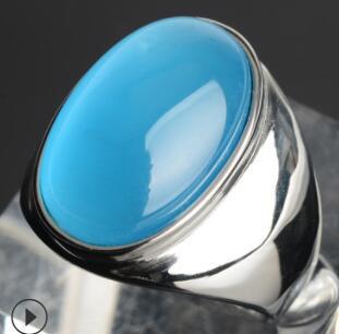 Luxury silver ring with vibrant blue cabochon stone, minimalist design, premium craftsmanship