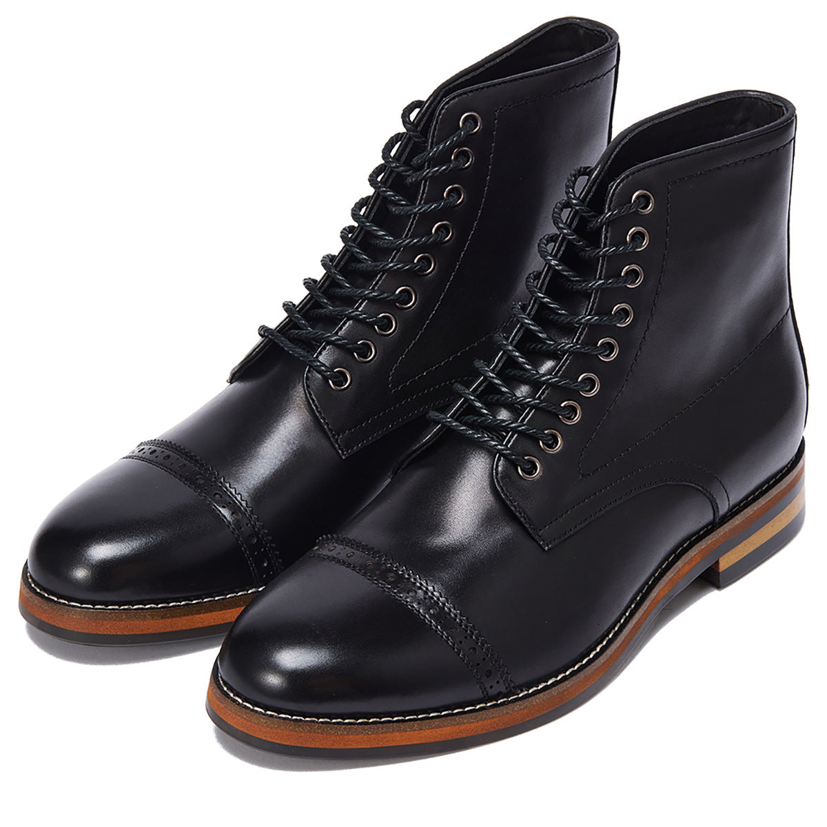 Black leather cap-toe boots with brogue detailing and contrast sole, minimalist luxury footwear