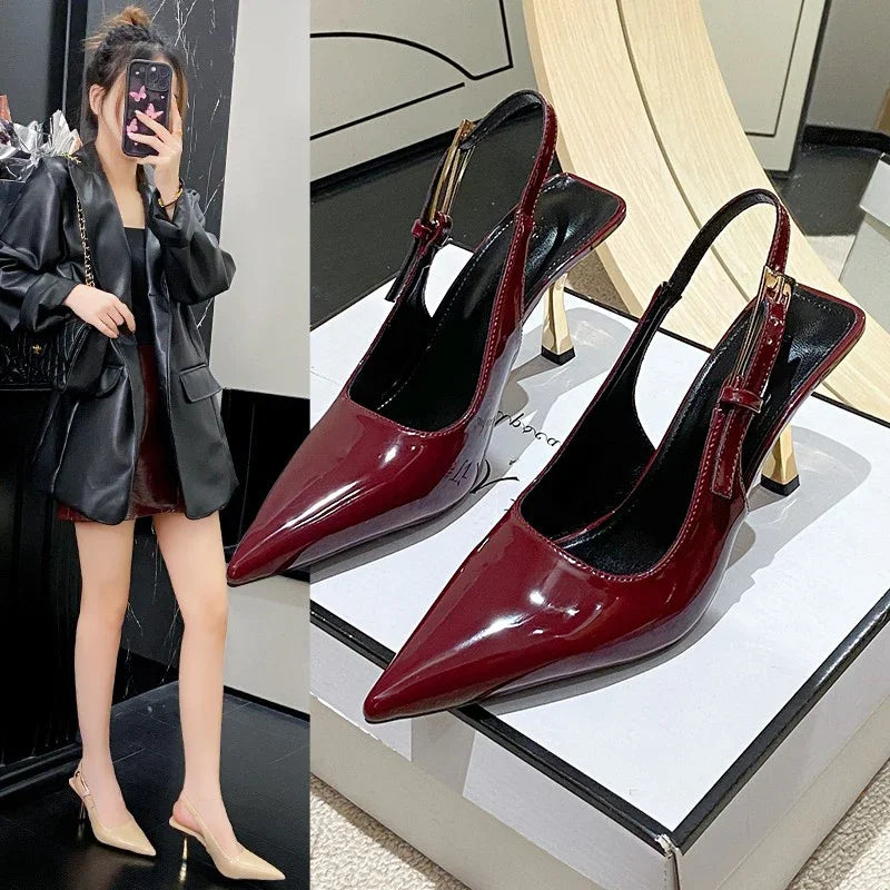 Luxury pointed-toe slingback heels in glossy burgundy, styled with black leather jacket for chic minimalist fashion.