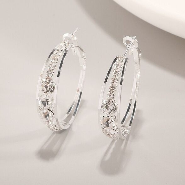 Sparkling crystal hoop earrings, minimalist luxury jewelry with clear gemstones and silver finish