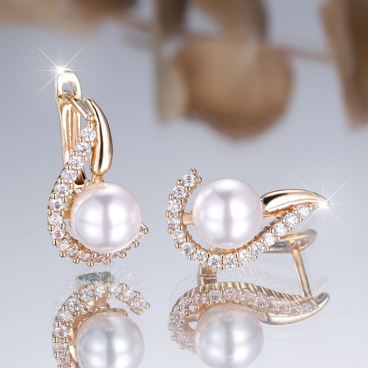 Luxury pearl earrings with rose gold and crystal accents, minimalist design