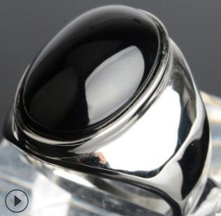 Polished silver ring with smooth black onyx cabochon, minimalist luxury jewelry design